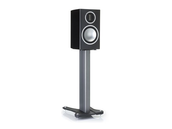 Gold 100, grille-less bookshelf speakers, with a piano black lacquer finish on a dedicated bookshelf stand.